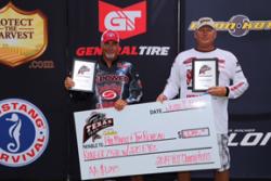 First-place finishers Tim Reneau (left) and Phil Marks (right) hold up their plaques and check at the TXTT Championship Event at Toledo Bend on June 7. 
